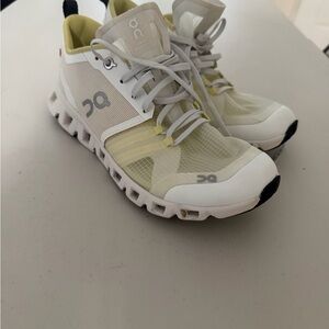 On Running White and Yellow Athletic Shoes